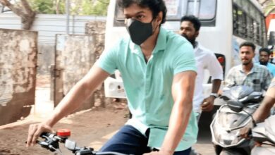 Vijay arrives on a bicycle